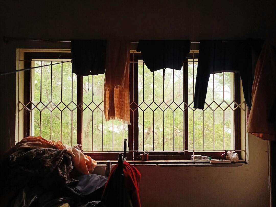person knitting by window