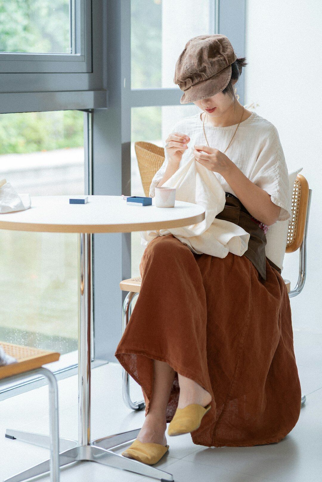 woman knitting sweater at home